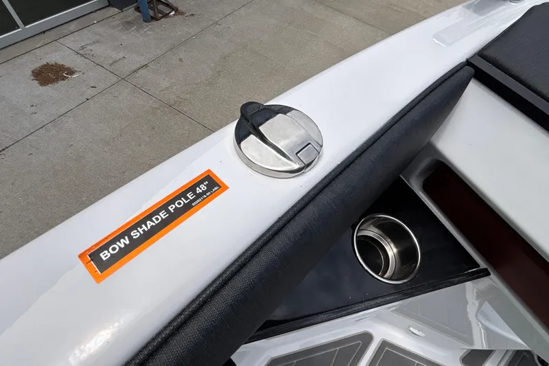 Slide: The Image of 2026 Monterey Elite 30 OB boat with bow shade pole and cup holder detail. - 89