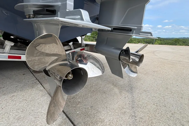 Slide: The Image of Sleek propellers of a 2026 Monterey Elite 30 OB boat on a trailer. - 9