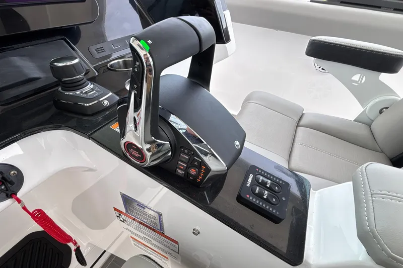 Slide: The Image of Control panel of 2026 Monterey Elite 30 OB boat with throttle and joystick. - 90