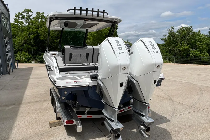Slide: The Image of 2026 Monterey Elite 30 OB boat with dual Mercury 300 V8 engines on a trailer. - 94