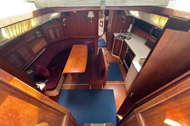 Slide: The Image of Interior of a 1990 Catalina 42 sailboat with wood finish and cozy seating area. - 18