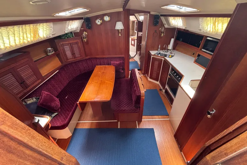 Slide: The Image of Interior of a 1990 Catalina 42 sailboat with wood finishes and cozy seating area. - 19