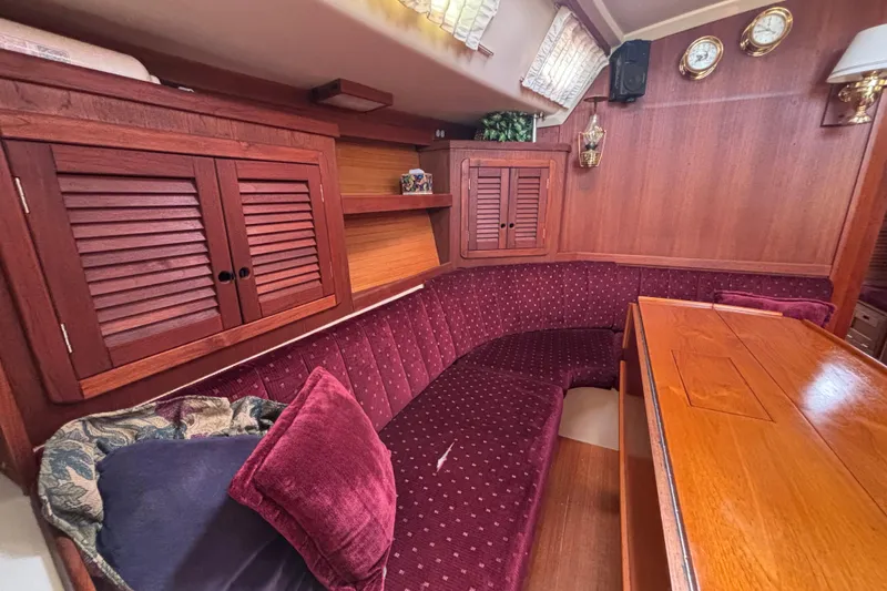 Slide: The Image of Interior of a 1990 Catalina 42 sailboat with plush seating and wooden cabinetry. - 21