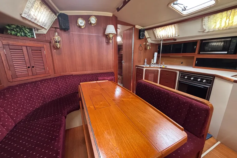 Slide: The Image of Interior of a 1990 Catalina 42 yacht with wood finishes and cozy seating area. - 22