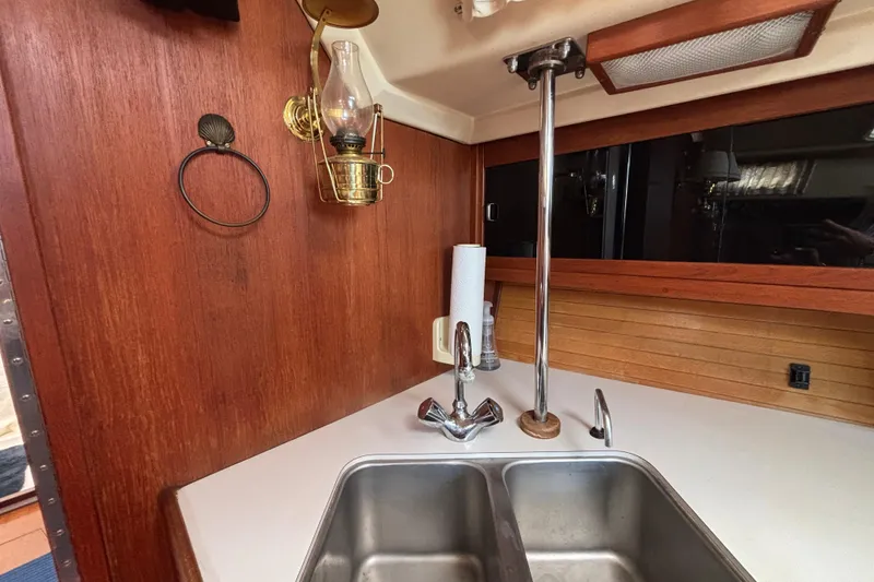 Slide: The Image of Galley of 1990 Catalina 42 sailboat with double sink and brass lantern. - 25