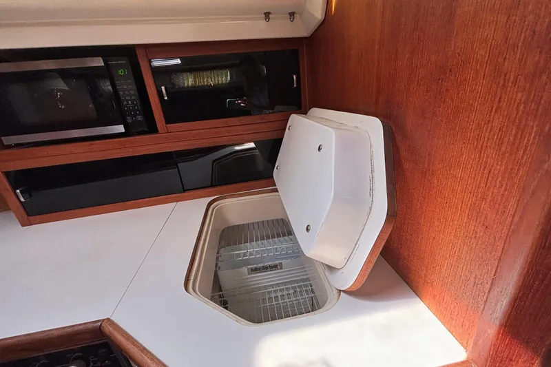 Slide: The Image of Interior of 1990 Catalina 42 yacht kitchen with microwave and storage. - 27