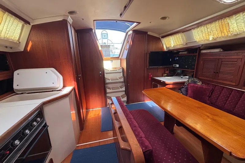 Slide: The Image of Interior of a 1990 Catalina 42 sailboat with wood finish and cozy seating area. - 30