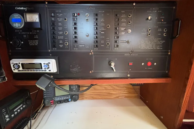 Slide: The Image of Control panel of a 1990 Catalina 42 yacht with various switches and meters. - 32