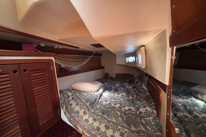 Slide: The Image of Cozy cabin interior of a 1990 Catalina 42 sailboat with a floral bedspread. - 34