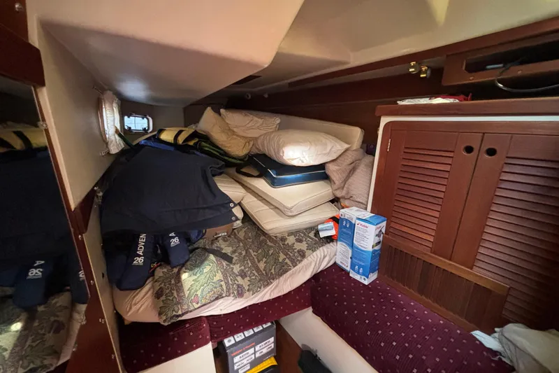 Slide: The Image of Cozy cabin interior of a 1990 Catalina 42 sailboat with cushions and storage. - 35