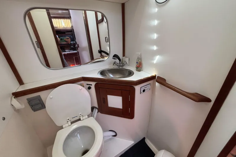 Slide: The Image of Bathroom interior of a 1990 Catalina 42 sailboat with sink and toilet. - 36
