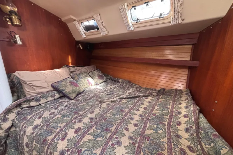 Slide: The Image of Cozy cabin interior of 1990 Catalina 42 sailboat with floral bedding and wood paneling. - 39