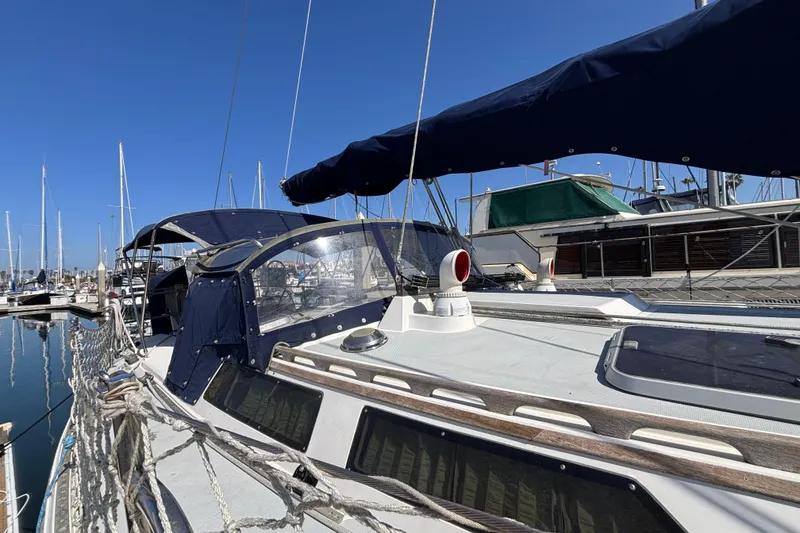 Slide: The Image of Sailboat Catalina 42, 1990 model, docked at marina under clear blue sky. - 4