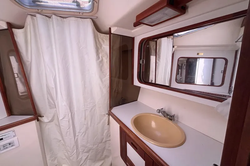 Slide: The Image of Bathroom interior of a 1990 Catalina 42 sailboat with sink and mirror. - 40