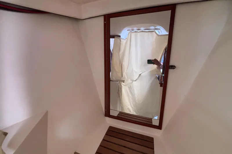 Slide: The Image of Mirror reflection inside 1990 Catalina 42 yacht cabin with wooden accents. - 42