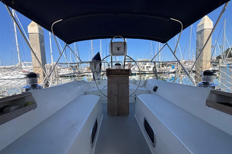 Slide: The Image of Cockpit view of a 1990 Catalina 42 sailboat docked in a marina. - 8