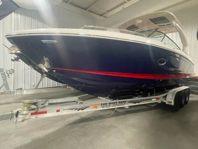 The Image of 2023 Chaparral 307 SSX boat on a trailer in an indoor storage facility. - 0