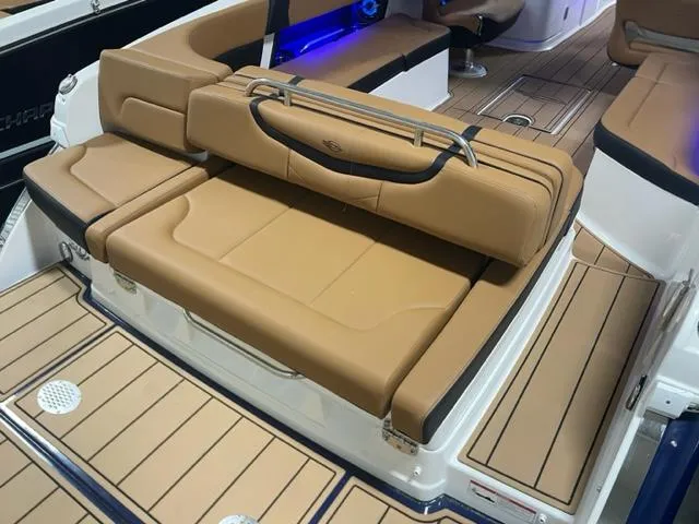 Slide: The Image of 2023 Chaparral 307 SSX boat with tan leather seating and teak flooring. - 18