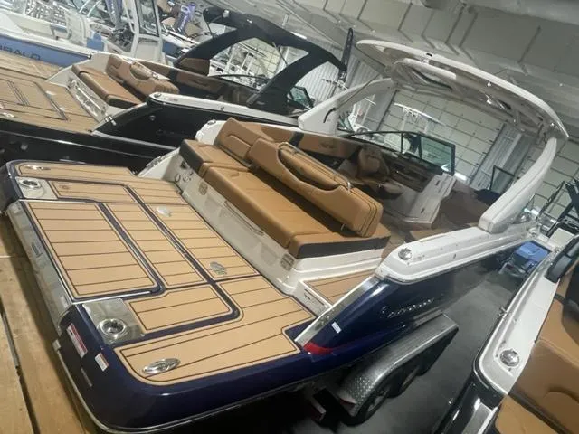Slide: The Image of 2023 Chaparral 307 SSX luxury boat with tan seating and spacious deck. - 2