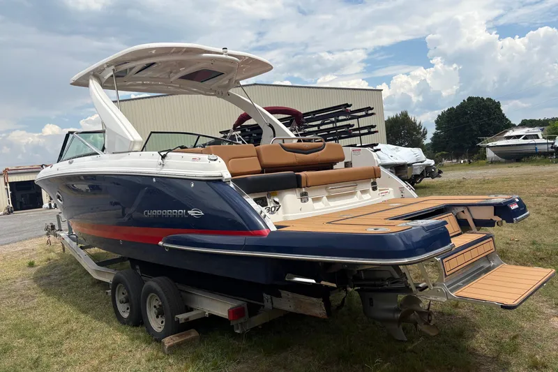 Slide: The Image of 2023 Chaparral 307 SSX boat on trailer, featuring sleek design and spacious seating. - 20