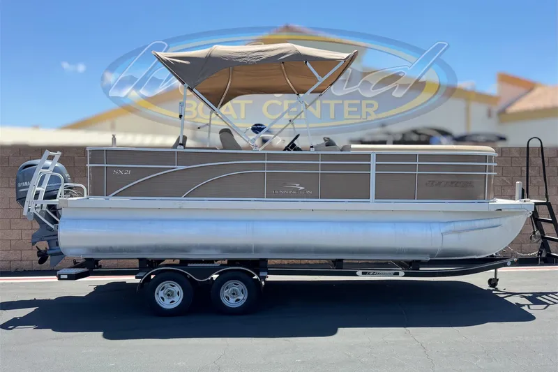 The Image of 2018 Bennington 21 SSX pontoon boat with canopy on trailer at dealership. - 0