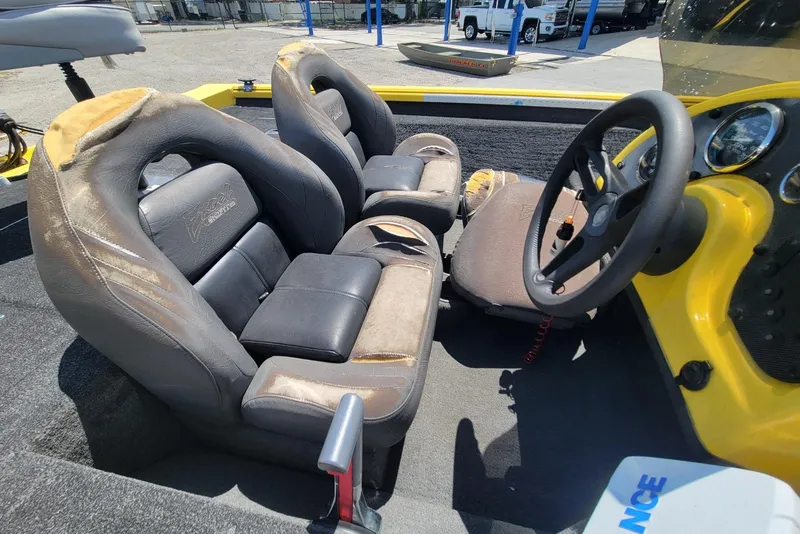 Slide: The Image of Interior of a 2011 Excel 1751 F4 boat with worn seats and steering wheel. - 12