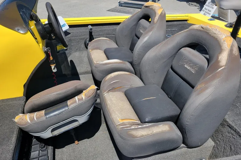 Slide: The Image of Interior of a 2011 Excel 1751 F4 boat with worn seats and steering wheel. - 13