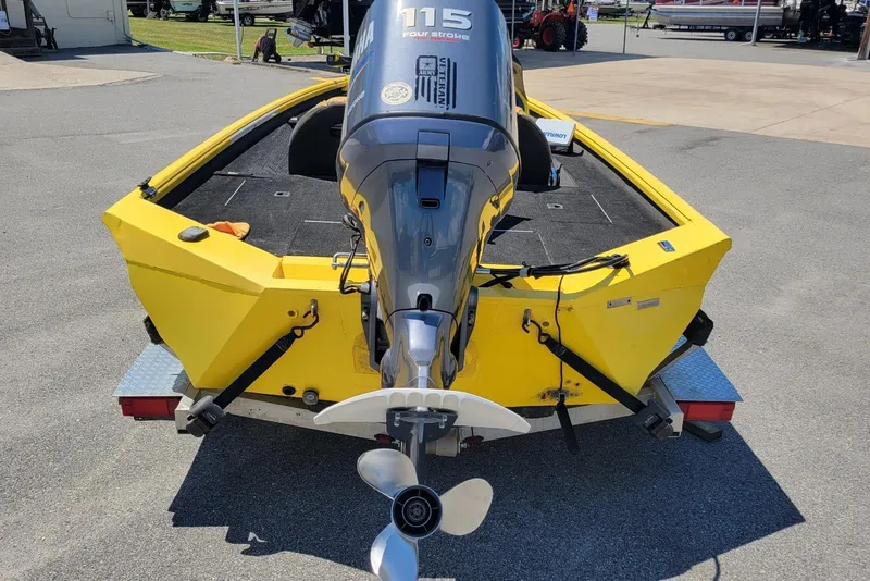 Slide: The Image of Yellow Excel 1751 F4 boat with Yamaha 115 outboard motor, parked on a trailer. - 4
