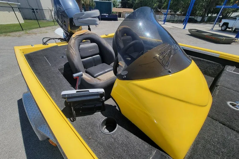 Slide: The Image of Yellow 2011 Excel 1751 F4 boat with windshield and seating, parked outdoors. - 5