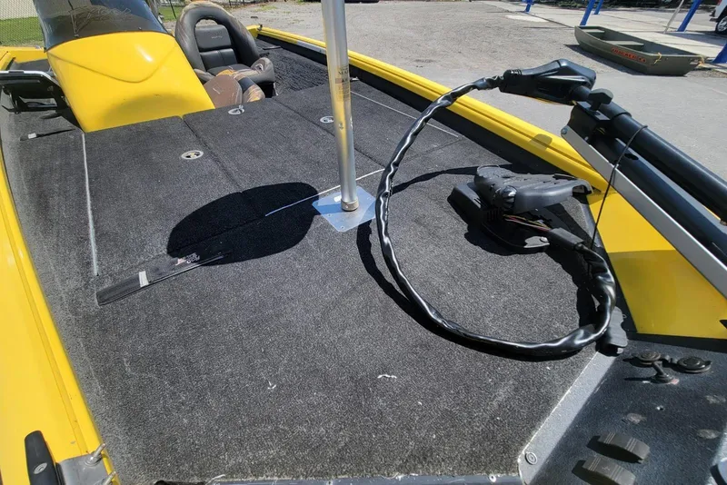 Slide: The Image of Yellow 2011 Excel 1751 F4 boat interior with carpeted deck and steering console. - 8
