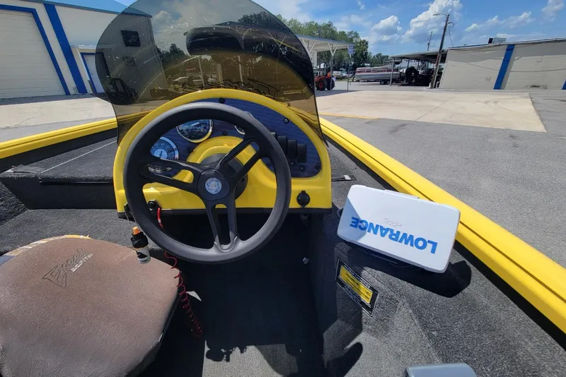 Slide: The Image of Interior of a 2011 Excel 1751 F4 boat with steering wheel and Lowrance device. - 9