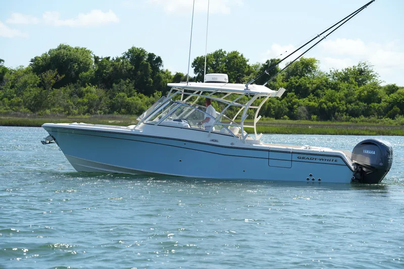 The Image of 2022 Grady-White Freedom 285 boat cruising on a serene waterway. - 0