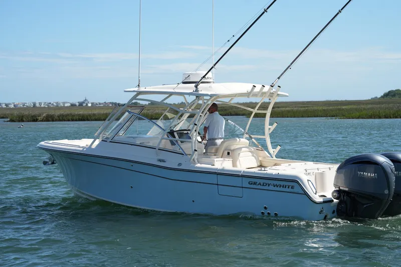 Slide: The Image of 2022 Grady-White Freedom 285 boat cruising on a scenic waterway. - 11