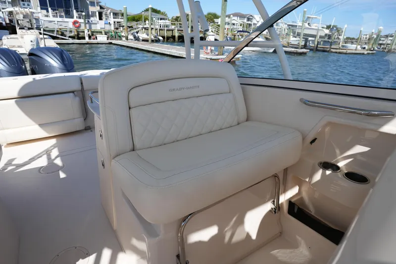 Slide: The Image of 2022 Grady-White Freedom 285 boat interior with luxurious seating and waterfront view. - 18