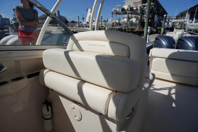 Slide: The Image of 2022 Grady-White Freedom 285 boat interior with cushioned seating and dual outboard motors. - 19