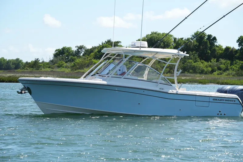 Slide: The Image of 2022 Grady-White Freedom 285 boat cruising on a sunny day. - 3