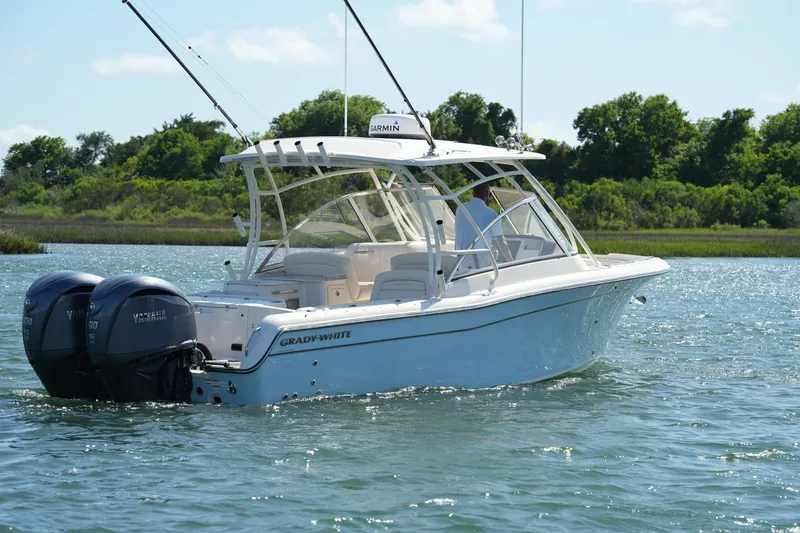 Slide: The Image of 2022 Grady-White Freedom 285 boat cruising on a sunny day with twin Yamaha engines. - 4