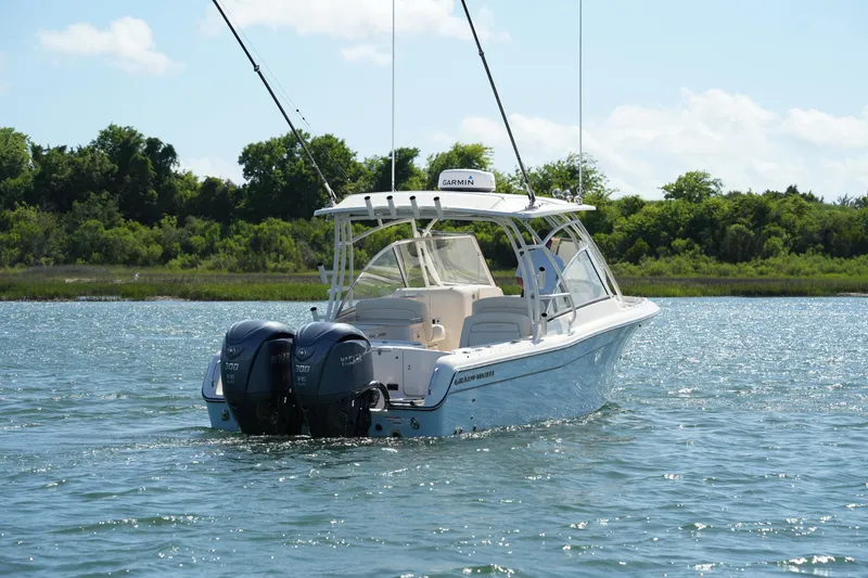 Slide: The Image of 2022 Grady-White Freedom 285 boat on water, featuring twin Yamaha engines. - 5