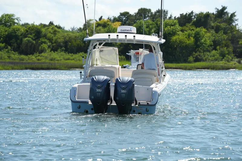 Slide: The Image of 2022 Grady-White Freedom 285 boat with dual Yamaha engines on a scenic waterway. - 6