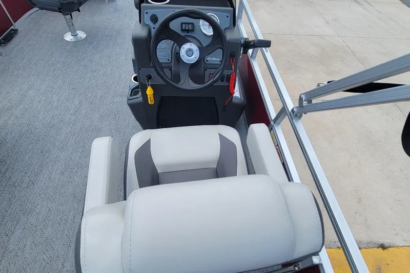Slide: The Image of 2026 Sun Tracker Bass Buggy 16 XL Select boat interior with steering console and seating. - 10