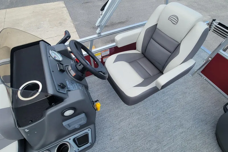 Slide: The Image of 2026 Sun Tracker Bass Buggy 16 XL Select boat interior with steering console and cushioned seat. - 11