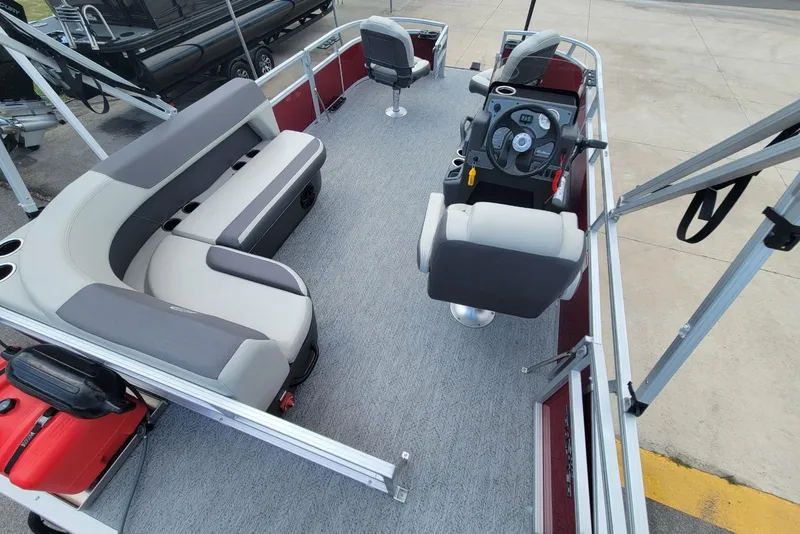 Slide: The Image of 2026 Sun Tracker Bass Buggy 16 XL Select pontoon boat interior with seating and steering console. - 13