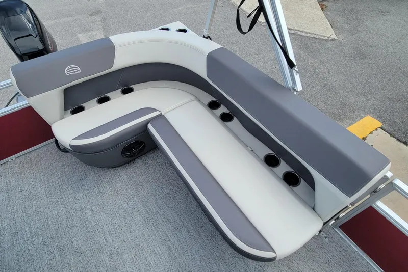 Slide: The Image of 2026 Sun Tracker Bass Buggy 16 XL Select boat seating with cup holders and gray upholstery. - 9