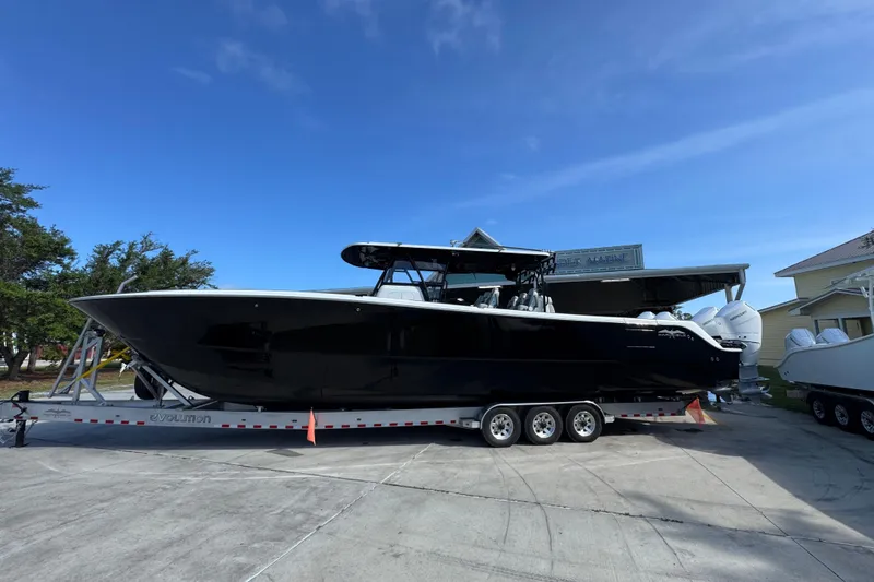 The Image of 2022 Invincible 46 Catamaran on trailer under clear blue sky. - 1