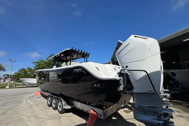 Slide: The Image of 2022 Invincible 46 Catamaran with Mercury engines on a trailer, parked outdoors. - 11