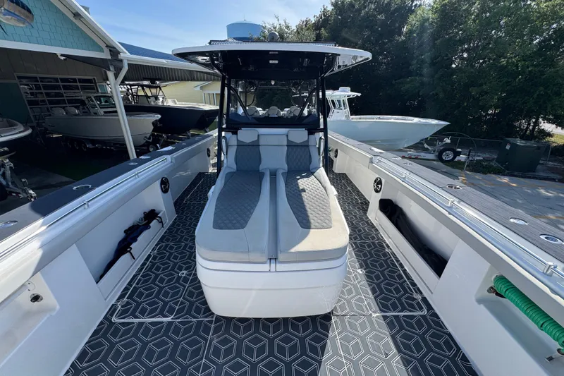 Slide: The Image of 2022 Invincible 46 Catamaran with sleek seating and geometric deck design. - 16
