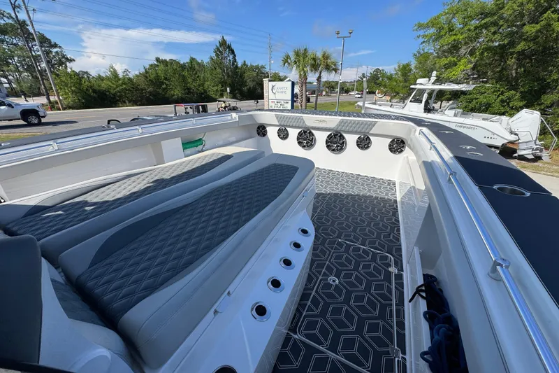 Slide: The Image of 2022 Invincible 46 Catamaran with sleek seating and modern design in a marina setting. - 17