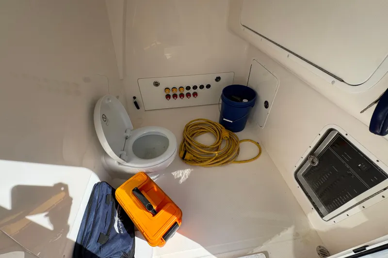 Slide: The Image of Interior of 2022 Invincible 46 Catamaran with toilet, storage, and equipment. - 22