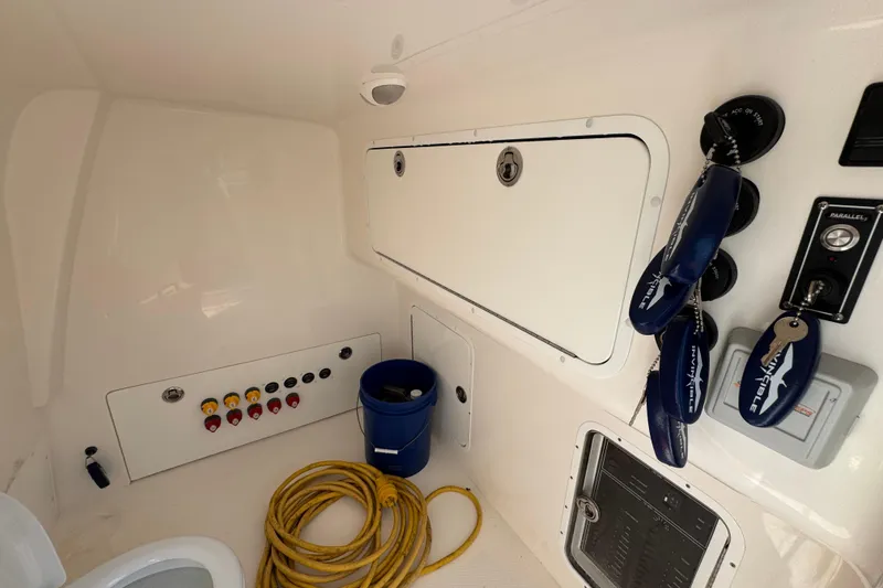 Slide: The Image of Interior of 2022 Invincible 46 Catamaran featuring control panel, storage, and marine equipment. - 23