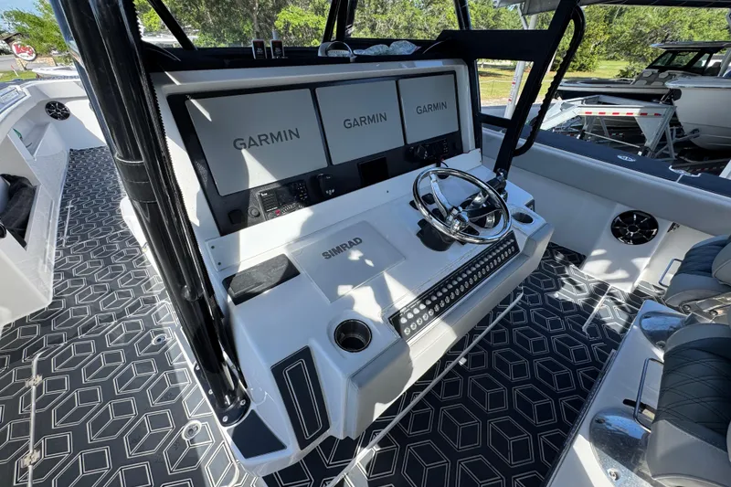 Slide: The Image of Helm of 2022 Invincible 46 Catamaran with Garmin displays and Simrad controls. - 29